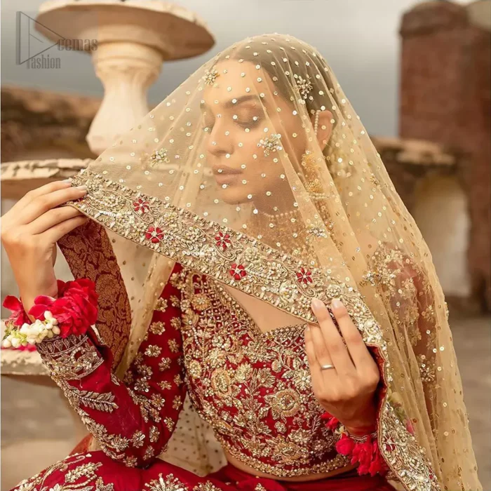 Our deep red bridal dress will make your special day even more perfect. Infused with classical glamour. Strike a breathtakingly elegant pose in this wedding dress. This artisan piece includes intricate hand embellishment. This highly skilled technique involves hand needle work to add beads and sequins to the fabric, giving your garments a unique look. The embroidery is done in the shades of light golden, antique and maroon thread work. The blouse is fully embellished and lehenga is adorned with floral details all over and thick embellished bottom. Furthermore the lehenga is also intensified with sprinkled floral motifs. Complete the look with golden net dupatta enhanced with sprinkled sequins on the ground and four sided embellished border.