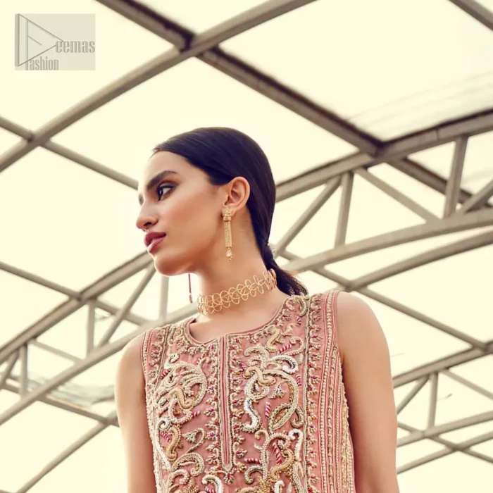 Delicately crafted and personifying chic elegance with an element of grandiose. You are all set to make a lasting impact with the divine royalty of this dress. The outfit is perfected with loaded dull golden, golden and antique work. The shirt is delicately hand crafted using the finest old age techniques and materials including kora, dabka, tilla, sequins and pearls. The back of the shirt is highlighted with cutwork embellishment. Furthermore it is also enhanced with thread embroidery. This outfit is comprises with peach raw silk bell bottom. Complete the look with peach organza dupatta decorated with sequins spray all over.