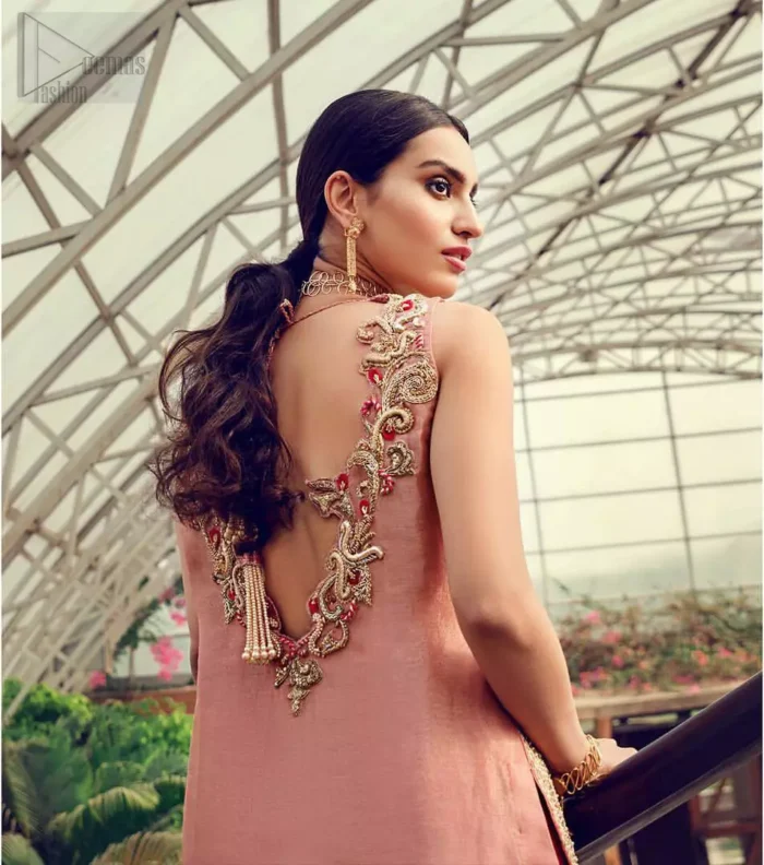 Delicately crafted and personifying chic elegance with an element of grandiose. You are all set to make a lasting impact with the divine royalty of this dress. The outfit is perfected with loaded dull golden, golden and antique work. The shirt is delicately hand crafted using the finest old age techniques and materials including kora, dabka, tilla, sequins and pearls. The back of the shirt is highlighted with cutwork embellishment. Furthermore it is also enhanced with thread embroidery. This outfit is comprises with peach raw silk bell bottom. Complete the look with peach organza dupatta decorated with sequins spray all over.