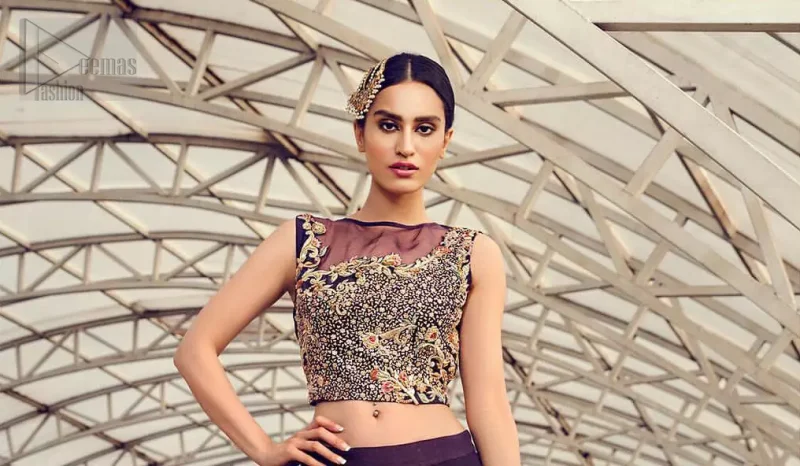 Captured in traditional silhouette, The bridal stands out due to its uniqueness and the perfect fusion of modern cut and traditional embroidery. This dress is beautifully decorated with heavy embroidery. It is highlighted with light golden kora, dabka, tilla, sequins and pearls. Blouse is fully enhanced with zardosi work and multiple color embroidery. It comes with full embellished lehenga adorned with floral booties and heavy embellished bottom. It is coordinated with plum organza dupatta which is sprinkled with sequins all over it.