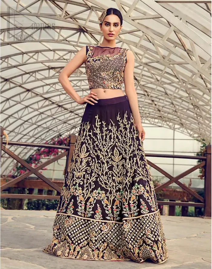 Captured in traditional silhouette, The bridal stands out due to its uniqueness and the perfect fusion of modern cut and traditional embroidery. This dress is beautifully decorated with heavy embroidery. It is highlighted with light golden kora, dabka, tilla, sequins and pearls. Blouse is fully enhanced with zardosi work and multiple color embroidery. It comes with full embellished lehenga adorned with floral booties and heavy embellished bottom. It is coordinated with plum organza dupatta which is sprinkled with sequins all over it.