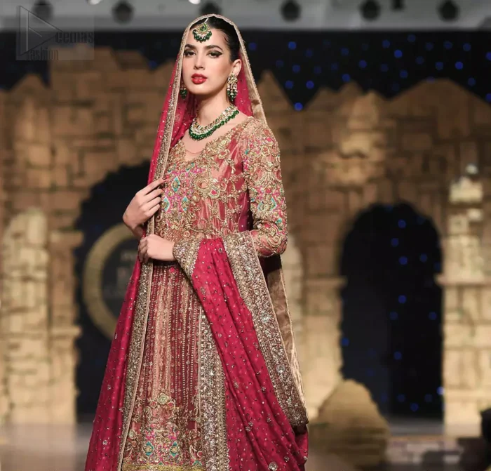 Nothing speaks of femininity and class louder than this outfit. This beautiful dress comes with burgundy A-Line frock with beautiful embellishment around the hem and vertically worked gold lines and it finished with a thick embellished border. The embroidery is done with golden, solver and antique shaded zardozi work. Furthermore it is also enhanced with multiple color thread embroidery in the floral motifs. Style it up with golden brocade sharara done with antique zardosi work at the bottom. This beautiful dress is comprises with burgundy dupatta sprinkled with sequins spray and four sided embroidered border.