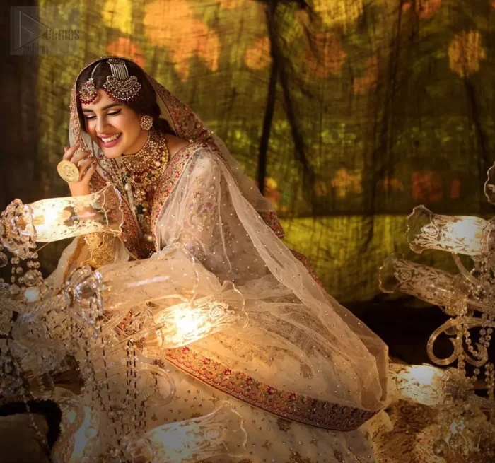 Delicately crafted and personifying chic elegance with an element of grandiose. This outfit is beautifully sculptured with geometric embroidery, adorned with heavy embellished bottom with golden and antique shaded kora, dabka, pearl and sequins work all over. Furthermore the outfit is emphasized with colorful thread work and mukesh embroidery. It is coordinated with ivory dupatta with sequins sprayed all over it along with zardozi work all around the edges to make the look complete.