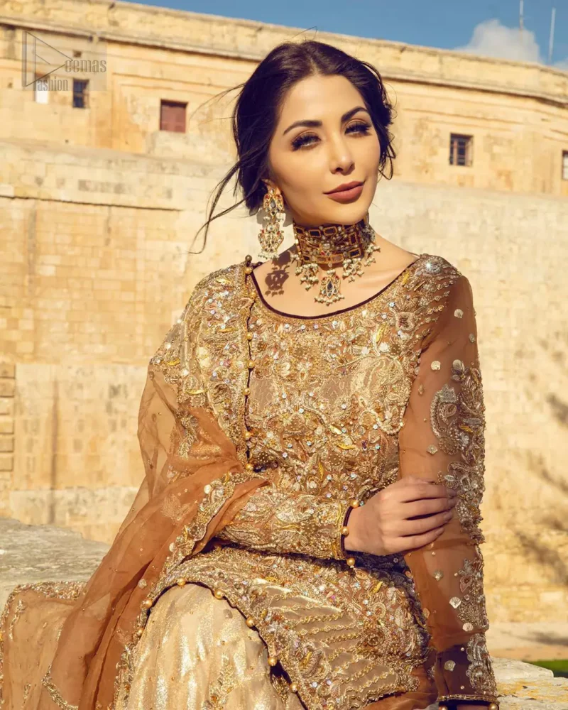 Dazzle in this made to perfection, richly embroidered ensemble accentuated with floral motifs and finished with scalp borders. Excellence of craftsmanship is evident with intricate detailing that features the use of kora, dabka, crystals, sequins and pearls. The Scalloped hemline is emphasided with dangling pearls. Balance the look with light golden lehenga adorned with golden, silver and antique shaded zardozi work. Dupatta comes with embellished alluring cut work floral border gives the perfect ending to this peplum.