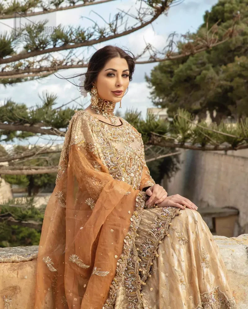 Dazzle in this made to perfection, richly embroidered ensemble accentuated with floral motifs and finished with scalp borders. Excellence of craftsmanship is evident with intricate detailing that features the use of kora, dabka, crystals, sequins and pearls. The Scalloped hemline is emphasided with dangling pearls. Balance the look with light golden lehenga adorned with golden, silver and antique shaded zardozi work. Dupatta comes with embellished alluring cut work floral border gives the perfect ending to this peplum.