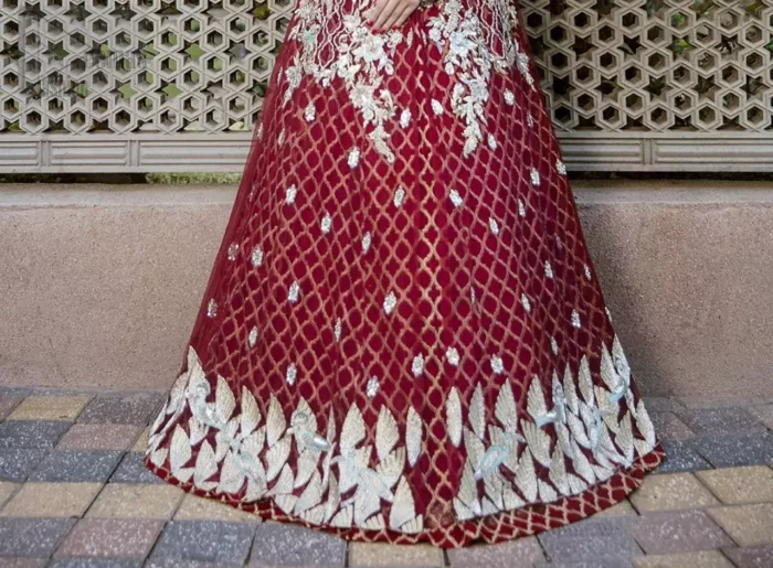 This front open marron maxi is creating a dreamy composition. The chic yet elegant front open maxi is decorated with floral embroidery , heavily embellished bodice and floral bunches. Hemline is even more enhanced with birds motifs finished with jamawar lining adorned with geometric patterns in it. The embroidery is done with silver and white kora, dabka, tilla, and pearls. It comes with straight trousers allured with sprinkled motifs on dupatta dupatta finished with silver lace all around the edges.  