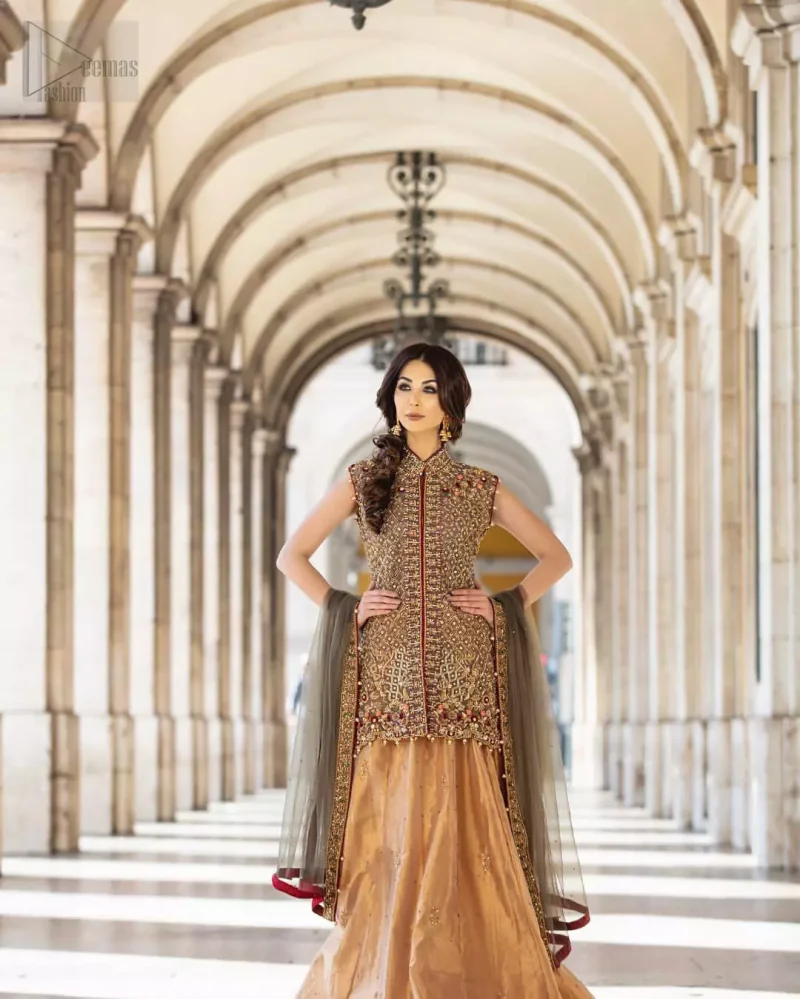 Our selection of wedding dresses offers simple evening glamour dresses. Add a taupe gray color to your wardrobe with our modern styled front open shirt enhanced with embellished geometric patterns. The neckline is beautifully designed with collar neck and scalloped hemline is emphasized with dangling pearls and multiple color embroidery. It is paired with taupe gray dupatta with one sided hand embellished border and sprinkled sequins all over. Compliment the look with fawn lehenga adorned with floral bunches. The combination of fawn and taupe gray is absolutely breathetaking.