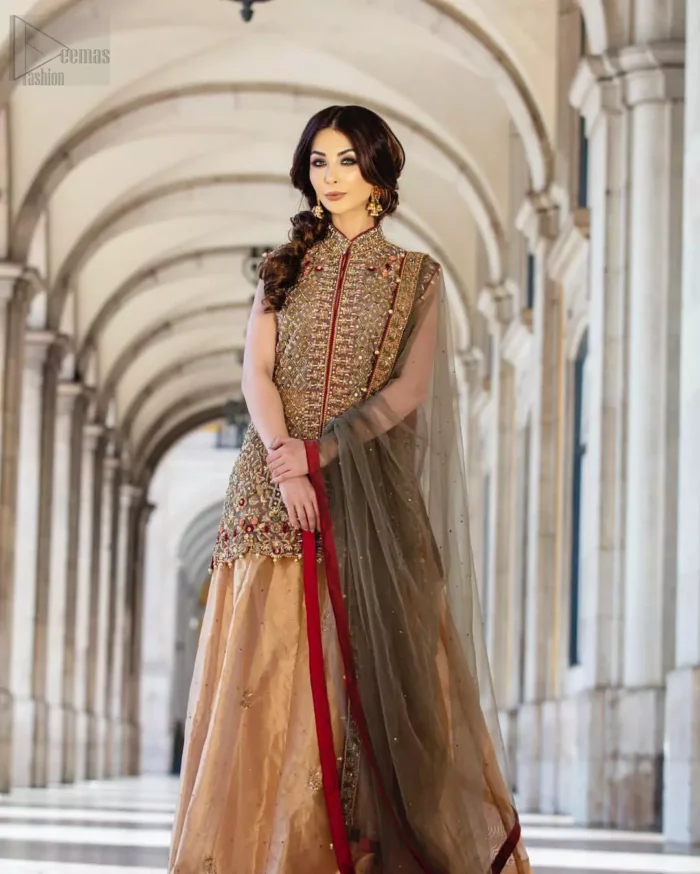 Our selection of wedding dresses offers simple evening glamour dresses. Add a taupe gray color to your wardrobe with our modern styled front open shirt enhanced with embellished geometric patterns. The neckline is beautifully designed with collar neck and scalloped hemline is emphasized with dangling pearls and multiple color embroidery. It is paired with taupe gray dupatta with one sided hand embellished border and sprinkled sequins all over. Compliment the look with fawn lehenga adorned with floral bunches. The combination of fawn and taupe gray is absolutely breathetaking.