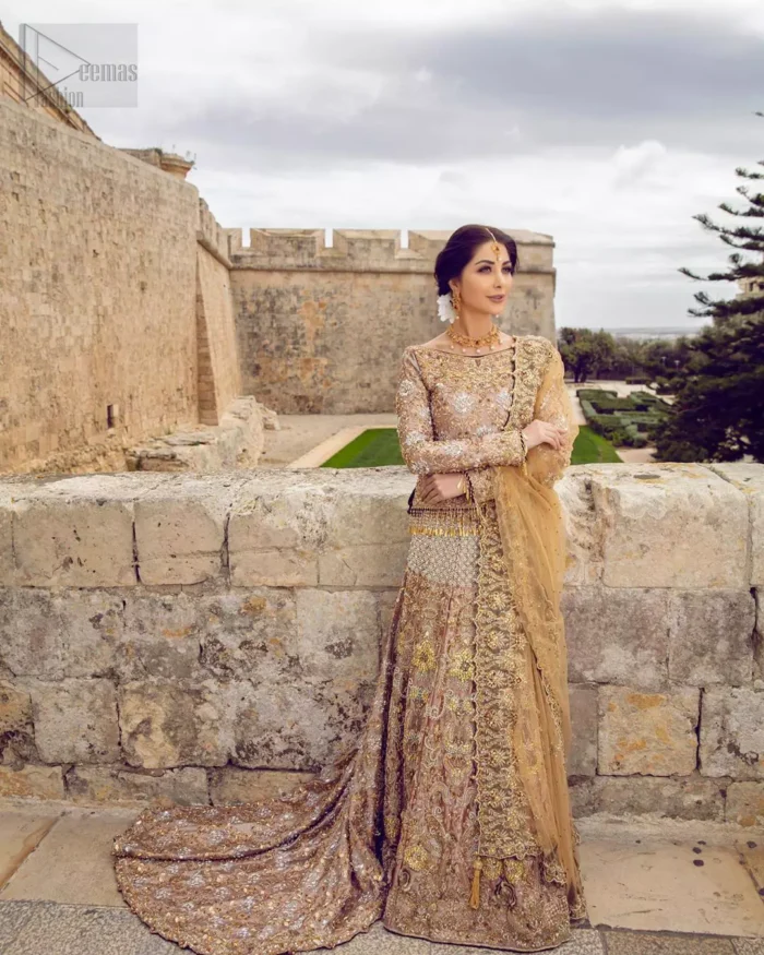 Strike a breathtakingly elegant pose in this wedding dress, designed with a beautiful blouse and a dramatic train. This artisan piece includes intricate hand-embellishment. This highly skilled technique involves hand needle work to add beads, kora, dabka, tilla and sequins to the fabric, giving our garments a unique look. The blouse is also enhanced with tassels on the hemline and back is adorned with horse shie neckline. Zardozi work is done in the shades of golden and silver. Dupatta is decorated with sequins spray on the canvas and finished with embroidered border on four sides which makes this outfit more beautiful.