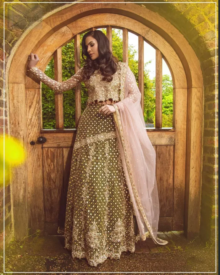 Nothing speaks of femininity and class louder than this mehndi outfits for bridesmaids. The motifs on the mehndi lehenga for a wedding are a true example of decorative and ornamental expression stylized in a contemporary way. The chic yet elegant mehndi green lehenga is decorated with zardozi embellished vertical lines, geometric patterns adorned with gotta work and floral bunches. Borders are even more enhanced with detailed motifs and finished with scallops. The blouse is fully decorated with floral embroidery all over with zardozi work in the shades of golden and antique. The look is completed with organza dupatta with embroidered lace borders and sequins spray all over.