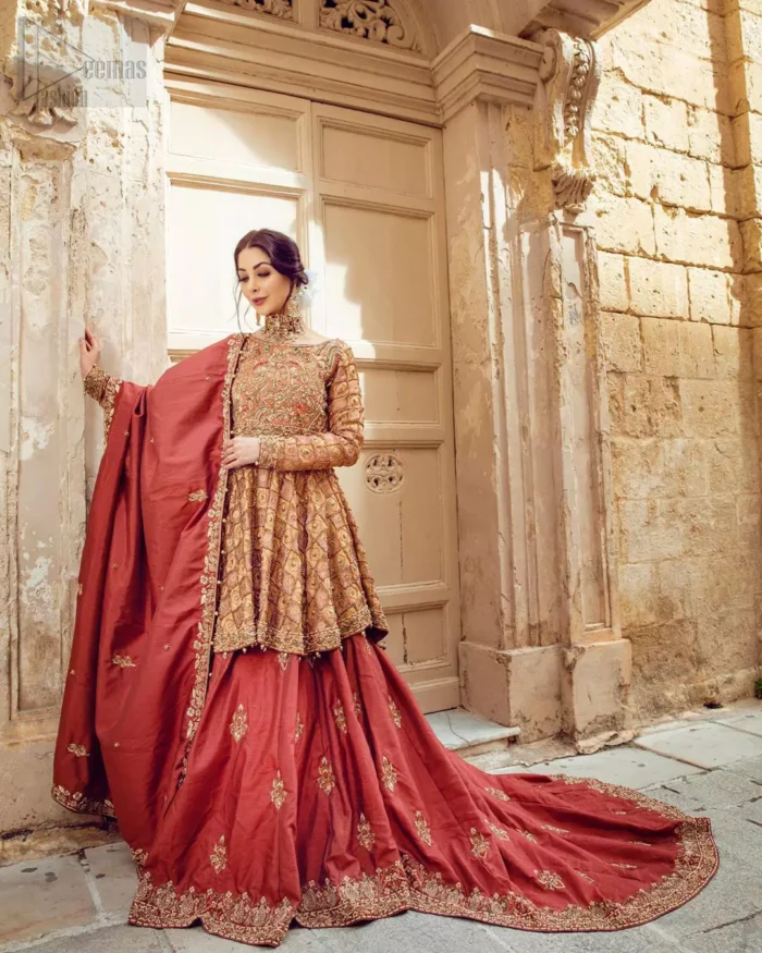 Chic and sophisticated perfectly describe this simply stunning wedding dress. This artisan piece includes intricate hand embellishment. This technique gives our garments a unique look, and helps to sustain a traditional craft carried out by skilled artisans across Asia. The short frock is fully embellished with zardozi work in the shades of golden and silver on tea rose canvas. Finished with dangling pearls on hemline. Compliment the look with coral back train lehenga exaggerated with embellished bottom and sprinkled floral bunches. The coral raw silk dupatta is emphasized with intricate embroidered borders.