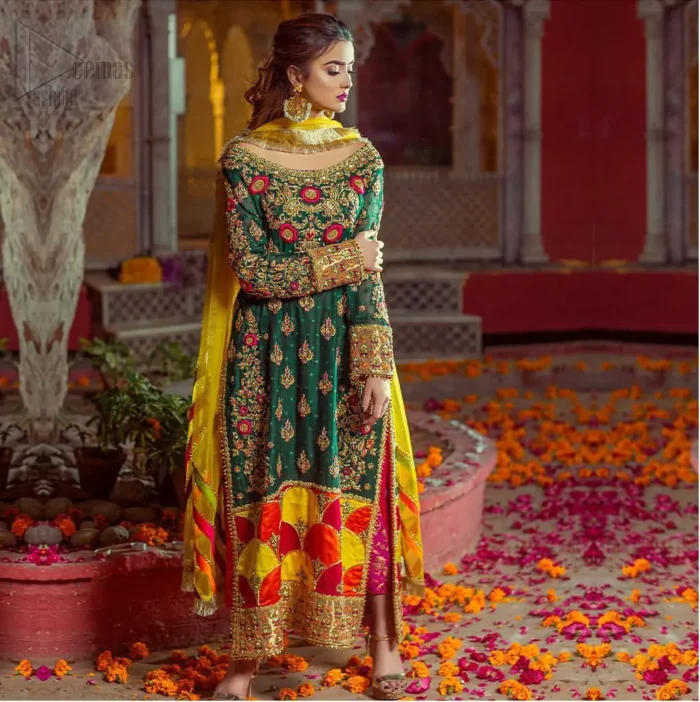 Beautifully elegant with a modern twist. This beautiful outfit comes with bottle green long shirt and colorful applique hemline, making an elegant, traditional and stylish mehndi dress. Excellence of craftsmanship is evident with intricate geometrical detailing that features the use of kora, dabka, crystals, sequins and glass beading. Furthermore it is enhanced with colorful floral motifs and golden zardozi work. It comprises with pink capri pants. Elegance is personified when it gets paired up with net dupatta with kiran on all sides and colorful strips on pallu.