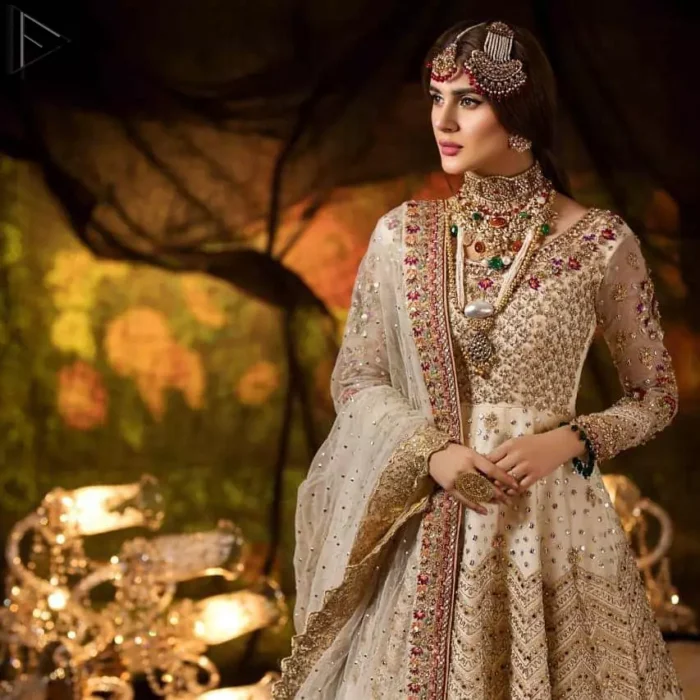 Delicately crafted and personifying chic elegance with an element of grandiose. This outfit is beautifully sculptured with geometric embroidery, adorned with heavy embellished bottom with golden and antique shaded kora, dabka, pearl and sequins work all over. Furthermore the outfit is emphasized with colorful thread work and mukesh embroidery. It is coordinated with ivory dupatta with sequins sprayed all over it along with zardozi work all around the edges to make the look complete.