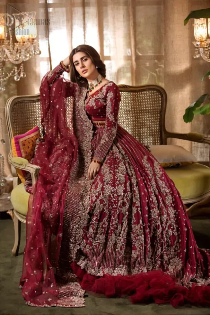 Make your big day more beautiful with our excessively embroidered lehenga blouse featuring delicately embellished back train along with scalloped finishing highlighted with antique embroidered detailing and intricately frilled inner that gives perfect ending to this outfit. The blouse is delicately crafted with antique zardosi work having full sleeves with dangling finishing. It is paired with an ethereal bridal dupatta focusing on kora and dabka handwork borders on all four sides, finished with scalloped borders. With a flowing trail, this is an ensemble that deserves to be flaunted.