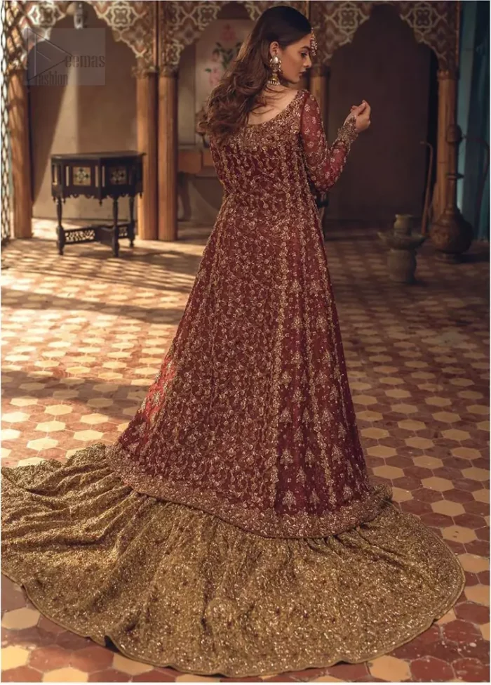 This wedding season, create a blissful aura with the treasure of love and elegance. An artistic vision of classic style and luxurious detailing, transpire into a truly romantic and iconic bridal for your big day. The front open floor length maxi is adorned with unique geometric patterns around the neckline and rest of the maxi is ornamented with floral embroidery. The kora, dabka, tilla and pearls embroidery is done in the shade of tan. Compliment the look with wide flared lehenga. The combination ofgolden with maroon is absolutely breathetaking. The dupatta incorporates beautifully designed borders on all four sides and sprinkled sequins to give it a perfect maharani look.
