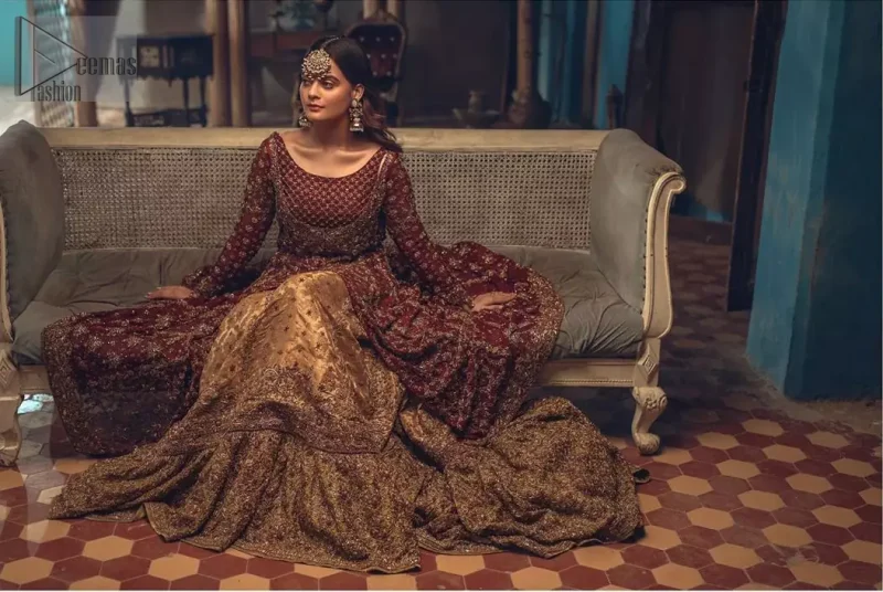 This wedding season, create a blissful aura with the treasure of love and elegance. An artistic vision of classic style and luxurious detailing, transpire into a truly romantic and iconic bridal for your big day. The front open floor length maxi is adorned with unique geometric patterns around the neckline and rest of the maxi is ornamented with floral embroidery. The kora, dabka, tilla and pearls embroidery is done in the shade of tan. Compliment the look with wide flared lehenga. The combination ofgolden with maroon is absolutely breathetaking. The dupatta incorporates beautifully designed borders on all four sides and sprinkled sequins to give it a perfect maharani look.