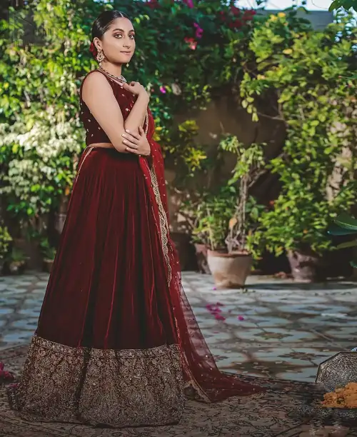 Let the crowd stare and make it worth their while when you walk wearing this maroon velvet lehenga blouse. Designed
