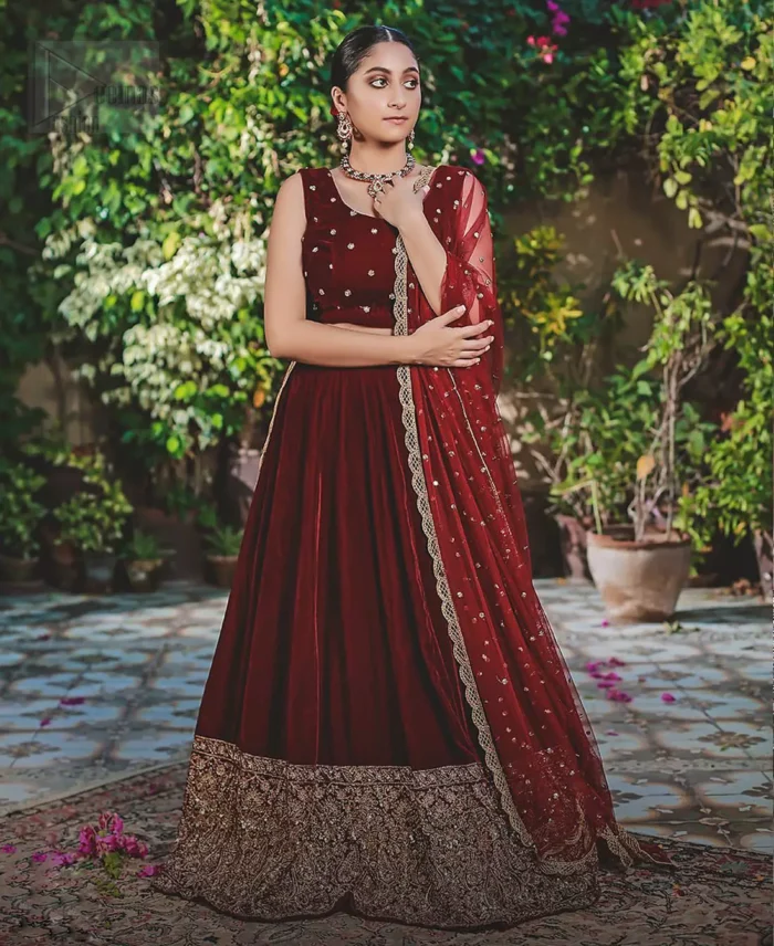 Let the crowd stare and make it worth their while when you walk wearing this maroon velvet lehenga blouse. Designed to flaunt your best features, the sleeveless blouse carries sequins spray with round neckline. Upholding the idea of simple is beautiful, you would definitely want to wear this for your next occasion or on your big day. The blouse is paired with maroon lehenga with hand embellishments on velvet base. The wide flare lehenga hemline is emphasized with intricate details with antique shaded kora, dabka, tilla and sequins work that gives the perfect ending t this outfit. Paired with maroon net dupatta having lace on all four sides.