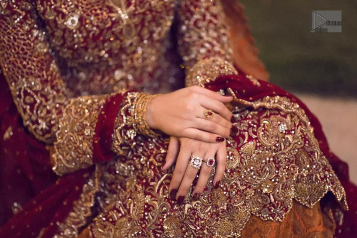 Pakistani Reception Wear - Maroon Shirt – Rust and Maroon Lehenga. You are all set to make a lasting impact with the divine royalty of this dress. This ravishing ensemble is sure to make you look like glamorous royalty with immaculate work covering every inch of the shirt. It boasts a pretty scallop hemline and full sleeves with zardozi embellishment. Compliment the look with flared lehenga. The combination of rust with maroon is absolutely breathtaking. Elegance is personified when it gets paired up with an all-over sequins spray-on dupatta with alternating scalloped borders detailing. This is an ensemble that deserves to be flaunted.