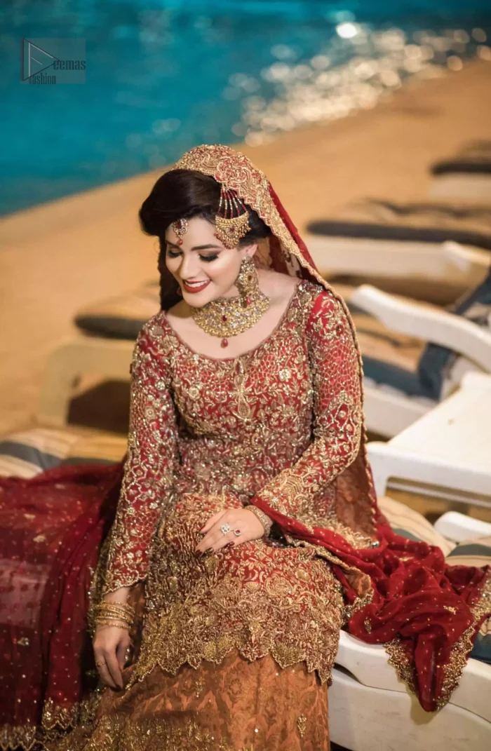 Pakistani Reception Wear - Maroon Shirt – Rust and Maroon Lehenga. You are all set to make a lasting impact with the divine royalty of this dress. This ravishing ensemble is sure to make you look like glamorous royalty with immaculate work covering every inch of the shirt. It boasts a pretty scallop hemline and full sleeves with zardozi embellishment. Compliment the look with flared lehenga. The combination of rust with maroon is absolutely breathtaking. Elegance is personified when it gets paired up with an all-over sequins spray-on dupatta with alternating scalloped borders detailing. This is an ensemble that deserves to be flaunted.