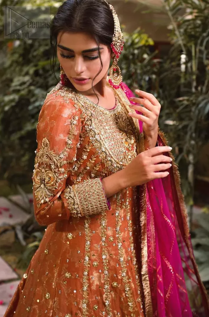Let the crowd stare and make it worth their while when you walk wearing this anarkali frock. Designed to flaunt your best features, the bodice carries intricate zardozi work. Furthermore this multiple panel frock is enhanced with gota work and beautiful applique on bottom embellished with golden kora, dabka, tilla, sequins and beads work. Pair it up with pink churidar pajama and pink organza dupatta emphasized with gota work and four sided kiran lace. Upholding the idea of simple is beautiful, you would definitely want to wear this for your next occasion.