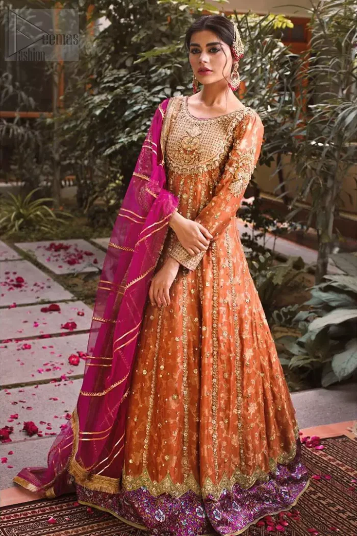 Let the crowd stare and make it worth their while when you walk wearing this anarkali frock. Designed to flaunt your best features, the bodice carries intricate zardozi work. Furthermore this multiple panel frock is enhanced with gota work and beautiful applique on bottom embellished with golden kora, dabka, tilla, sequins and beads work. Pair it up with pink churidar pajama and pink organza dupatta emphasized with gota work and four sided kiran lace. Upholding the idea of simple is beautiful, you would definitely want to wear this for your next occasion.