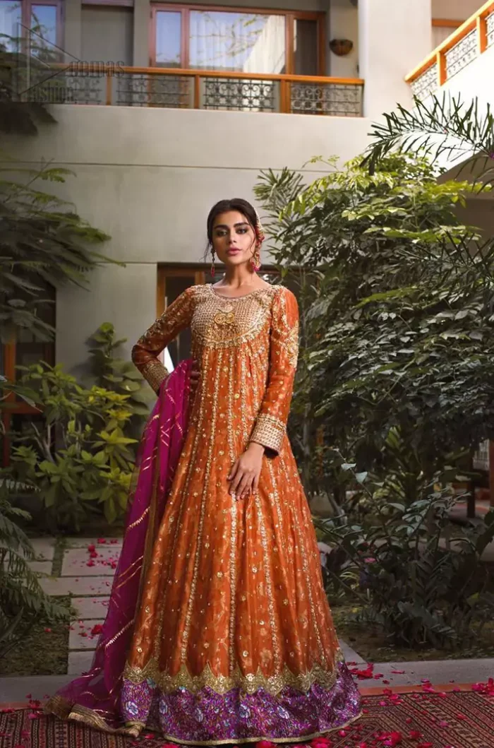 Let the crowd stare and make it worth their while when you walk wearing this anarkali frock. Designed to flaunt your best features, the bodice carries intricate zardozi work. Furthermore this multiple panel frock is enhanced with gota work and beautiful applique on bottom embellished with golden kora, dabka, tilla, sequins and beads work. Pair it up with pink churidar pajama and pink organza dupatta emphasized with gota work and four sided kiran lace. Upholding the idea of simple is beautiful, you would definitely want to wear this for your next occasion.
