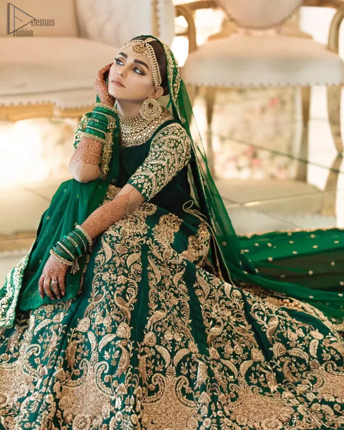 This artisanal piece is rendered in grace and timelessness. This outfit makes a statement in this stunningly floraison, perfect blend of glamour and tradition with outstanding craftsmanship and gorgeous detailing. This mehndi dress in a dreamy shade of green, enhanced with hand embellishments on neckline and sleeves. The wide flared lehenga is an example of remarkable handiwork with a lot of attention to detail. The sculptured embroidery is in the shade of golden. Complete the look with bottle green organza dupatta emphasized with tiny floral motifs on the ground and four sided embellished border.
