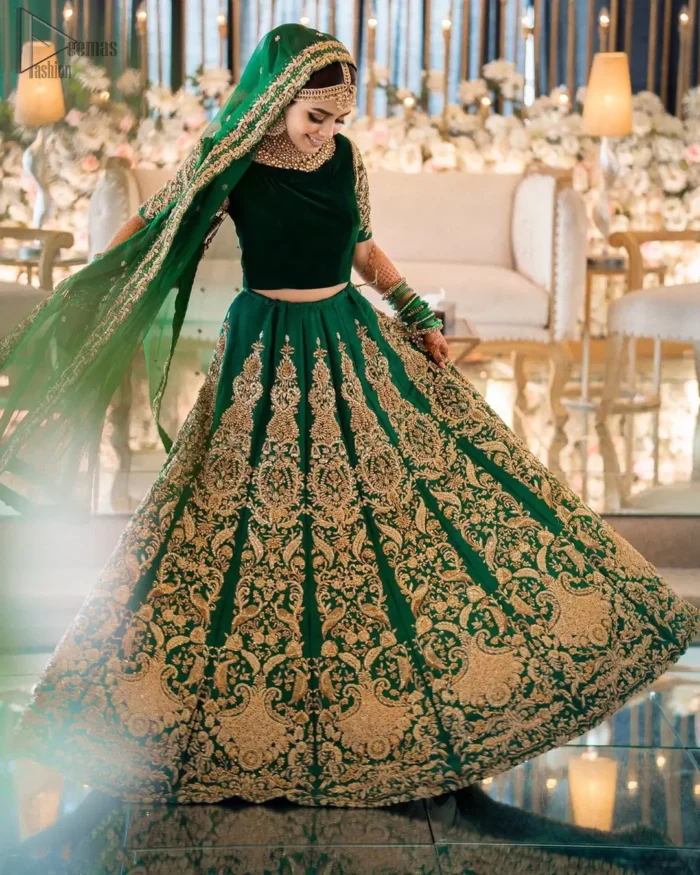 This artisanal piece is rendered in grace and timelessness. This outfit makes a statement in this stunningly floraison, perfect blend of glamour and tradition with outstanding craftsmanship and gorgeous detailing. This mehndi dress in a dreamy shade of green, enhanced with hand embellishments on neckline and sleeves. The wide flared lehenga is an example of remarkable handiwork with a lot of attention to detail. The sculptured embroidery is in the shade of golden. Complete the look with bottle green organza dupatta emphasized with tiny floral motifs on the ground and four sided embellished border.