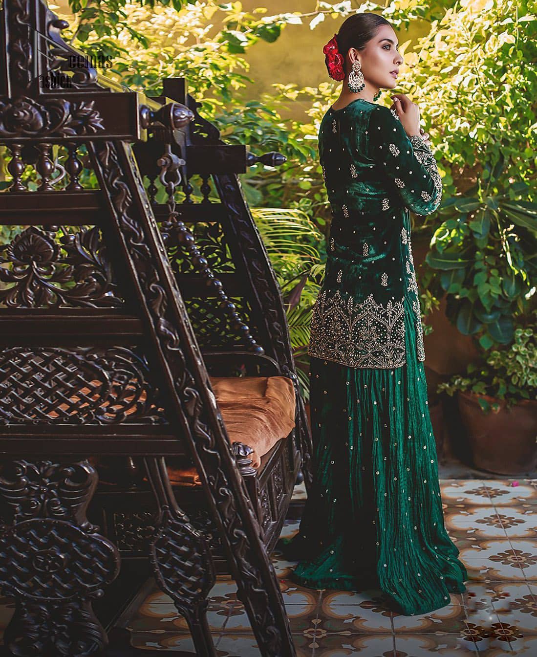 This mehndi outfit is a true example of decorative and ornamental expression stylized in a contemporary way. The dress comes with a bottle green velvet shirt with beautiful embellished motifs on the ground and vertically worked lines and it finished with a thick embellished border with silver zardozi work. Pair it up with bottle green crushed sharara adorned with scattered sequins all over. To complete the look, go with chiffon dupatta decorated with sequins spray all over.