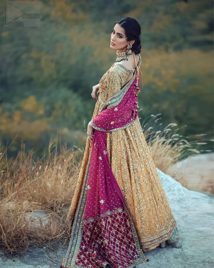 This exceptionally detailed anarkali frock is cut in a seductive fit and flare silhouette that’s sure to turn heads. The bodice with round neckline is adorned in richly beaded work with fabulous sparkle and zardozi work. Furthermore the panels of the shirt is vertically adorned with golden kora, dabka, tilla work and various flora motifs meticulously using on the ground. The frock is comprises with ferozi lehenga emphasized with criss cross patterns done with golden embellishment. Elegance is personified when it gets paired up with an embroidered dupatta with alternating motifs and sequins detailing.
