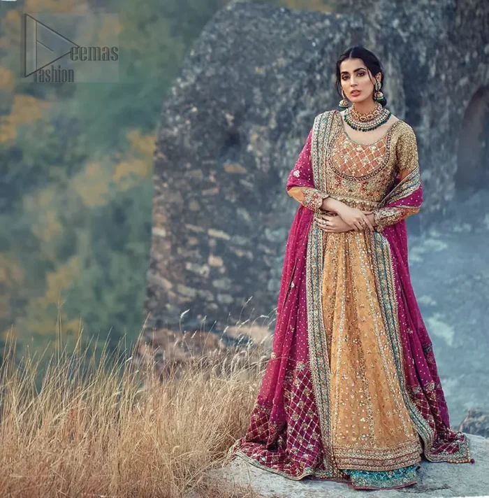 This exceptionally detailed anarkali frock is cut in a seductive fit and flare silhouette that’s sure to turn heads. The bodice with round neckline is adorned in richly beaded work with fabulous sparkle and zardozi work. Furthermore the panels of the shirt is vertically adorned with golden kora, dabka, tilla work and various flora motifs meticulously using on the ground. The frock is comprises with ferozi lehenga emphasized with criss cross patterns done with golden embellishment. Elegance is personified when it gets paired up with an embroidered dupatta with alternating motifs and sequins detailing.
