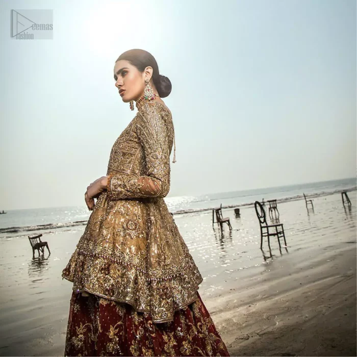 This wedding season, create a blissful aura with the treasure of love and elegance. An artistic vision of classic style and luxurious detailing infused with a bohemian spirit, transpire into a truly romantic and iconic bridal for your big day. The golden double layered peplum is heavily laden with zardozi and the perfect blend of traditional flamboyance and modern elegance in design. Pair it up with maroon lehenga enhanced with golden zardozi work. To complete the look, go with teel dupatta scattered with sequins all over the ground and heavily embellished borders to give it a perfect maharani look.
