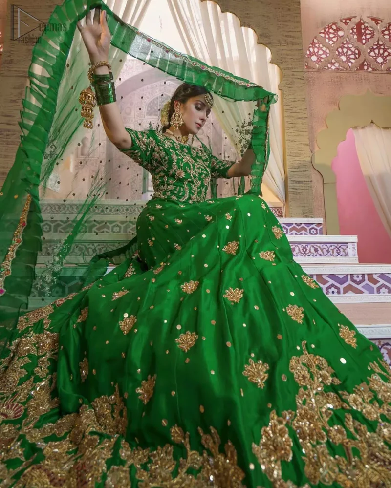 Nothing speaks of femininity and class louder than this green mehndi outfits for bridesmaids. This beautiful outfit comes with a green lehenga which is beautifully embellished with motifs, sprinkled with sequins and it finished with a thick embellished border. The blouse is breathtakingly ornamented with floral bootis which covers every inch of the blouse. The dupatta incorporates beautifully designed scalloped borders and frilled on all four sides. The kora, dabka, tilla, sequins and pearls work are done in the shades of golden.