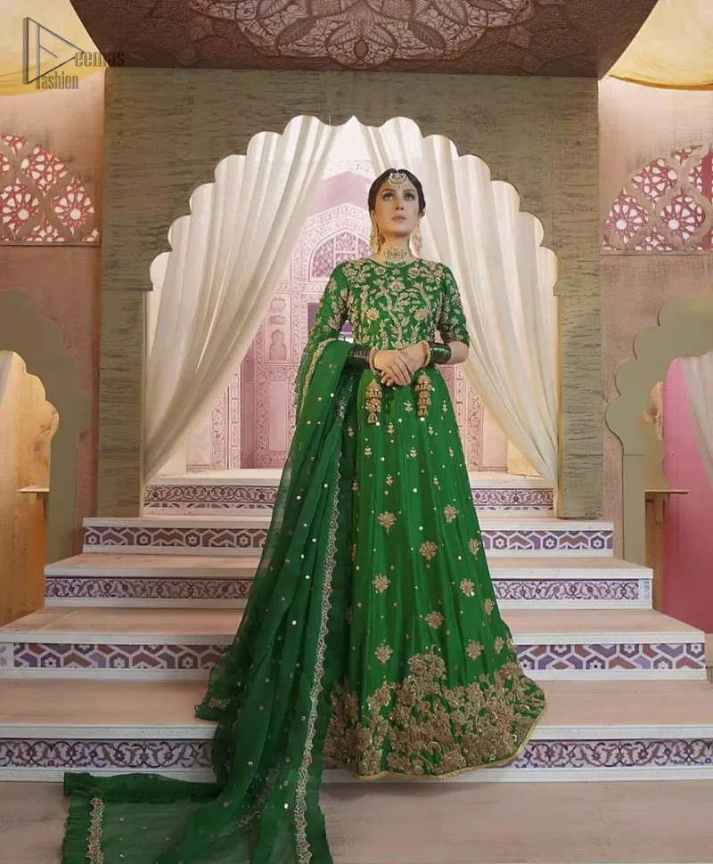 Nothing speaks of femininity and class louder than this green mehndi outfits for bridesmaids. This beautiful outfit comes with a green lehenga which is beautifully embellished with motifs, sprinkled with sequins and it finished with a thick embellished border. The blouse is breathtakingly ornamented with floral bootis which covers every inch of the blouse. The dupatta incorporates beautifully designed scalloped borders and frilled on all four sides. The kora, dabka, tilla, sequins and pearls work are done in the shades of golden.