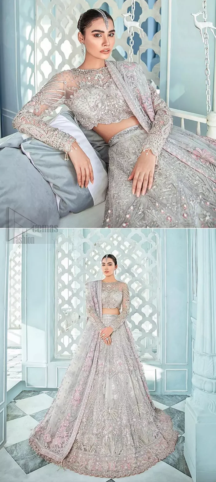 Its an unforgettable look that will effortlessly take you from day to night this festive season. Unique craftsmanship and detailed embellishments bring heavenly hued gossamer fabrics to life, creating delicate yet flamboyant pieces of art in our collection. The light gray blouse is delicately crafted with silver zardozi embellishment and finishing with scalloped sleeves and tassels. It is coordinated with lehenga which is heavily laden with sumptuous details of zardozi, applique, kora and dabka. Furthermore the lehenga is enhansed with pink applique bottom. Complete the look with light gray organza dupatta with rich embroidered floral motifs places artistically on the dupattas pallu gives a royal look.