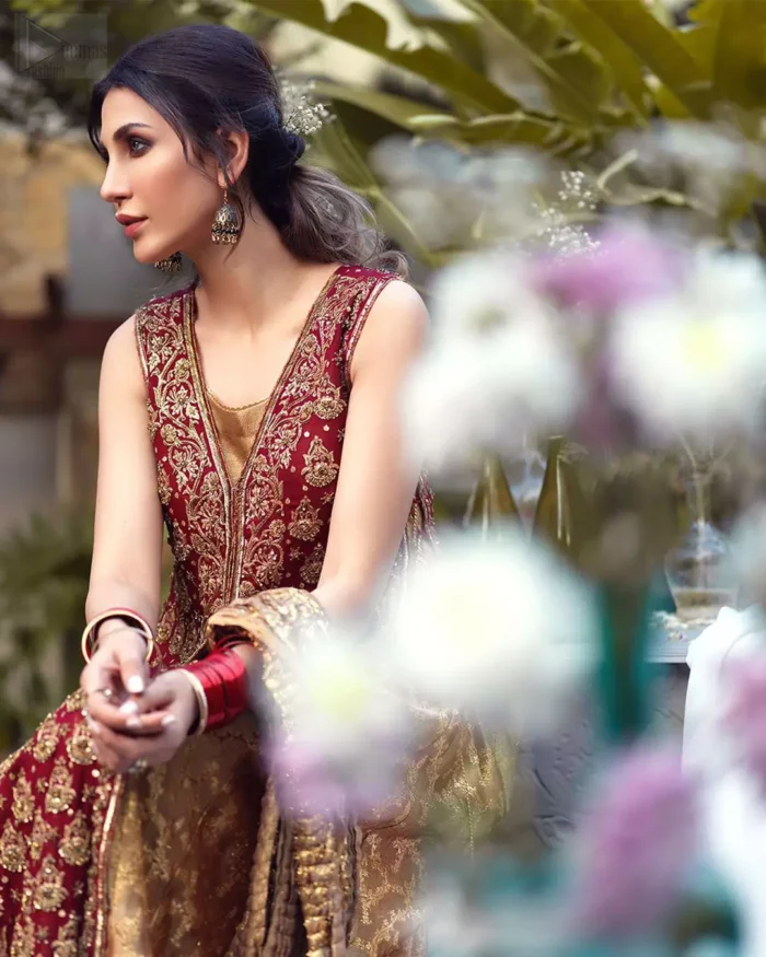 Impeccably on trend, this chic, romantic and oh-so-elegant ensemble is perfect for the one who want to mix vintage touches in with more daring and contemporary designs. Unique craftsmanship and detailed embellishments on the maroon front open shirt, done with golden zardozi. Furthermore the back of the shirt is also emphasized with zardozi work and scattered sequins all over the back. It comprises with golden inner maxi enhanced with maroon embellished applique on the bottom. Pair it up with golden brocade churidar pajama and golden crushed dupatta.
