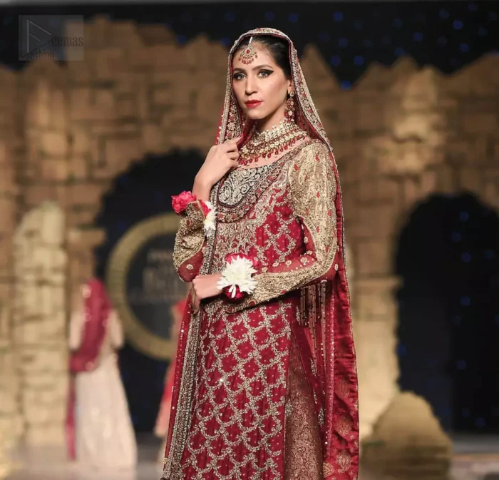 Classic, timeless and truly beautiful, our bridal dress is perfect for your unforgettable day. A perfectly pretty combination of antique and light gold embellishment, this wedding dress is elegant and eye-catching in equal measure. The bodice is crafted artfully with embellished bodice and rest of the shirt is adorned with geometric patterns.  Finished with fine zardozi work on the hemline and decorative. Accompanied by a banarsi chatta patti lehenga enhanced with antique shaded kora, dabka and tilla embroidery. Finish the look with maroon organza dupatta having embroidery on all four sides.