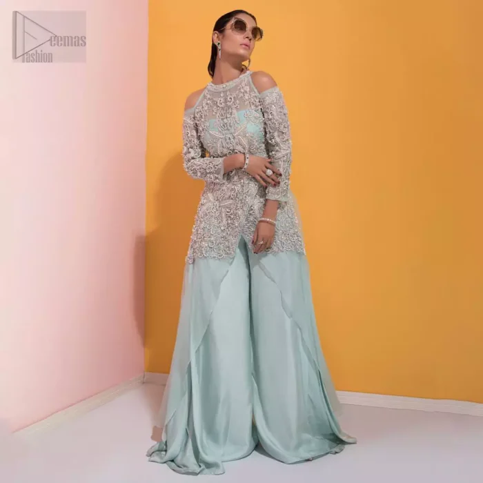 A fashion forward style statement that is contemporary yet chic. This handcrafted remarkable ensemble includes art deco design elements. Unique craftsmanship and detailed embellishments on the pastel green shirt creating delicate yet flamboyant pieces of art in your wardrobe collection. Cold Shoulder sleeves and halter illusion neckline make it more remarkable. To complete the look, go with palazzo pants and organza dupatta sprinkled with sequins all over.