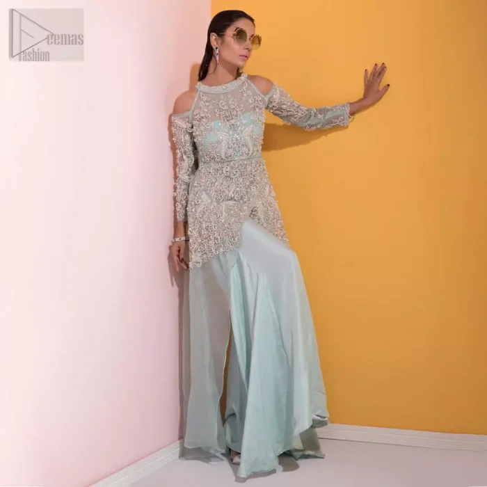 A fashion forward style statement that is contemporary yet chic. This handcrafted remarkable ensemble includes art deco design elements. Unique craftsmanship and detailed embellishments on the pastel green shirt creating delicate yet flamboyant pieces of art in your wardrobe collection. Cold Shoulder sleeves and halter illusion neckline make it more remarkable. To complete the look, go with palazzo pants and organza dupatta sprinkled with sequins all over.