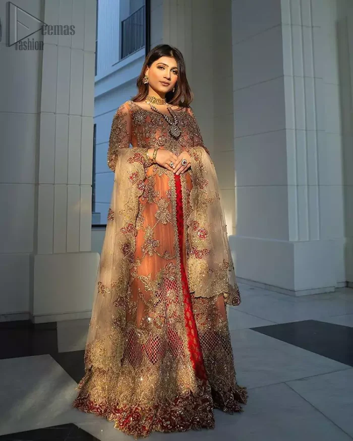 Details make perfection and perfection is not a detail”-DaVinci. This beautiful quote embodies what the DeemasFashion tries to achieve in its every ensemble which is customised to perfection. This beautiful play of red and orange  makes for a stunning. The upper layer of maxi is beautifully crafted with multiple color zardozi work and embroidered jaal. The bottom of inner are even more enhanced with golden zardozi embellishment and finished with scallops. It comprises with churidar pajama and fawn chiffon dupatta. The embellished alluring cut work floral border gives the perfect ending to veil or dupatta.
