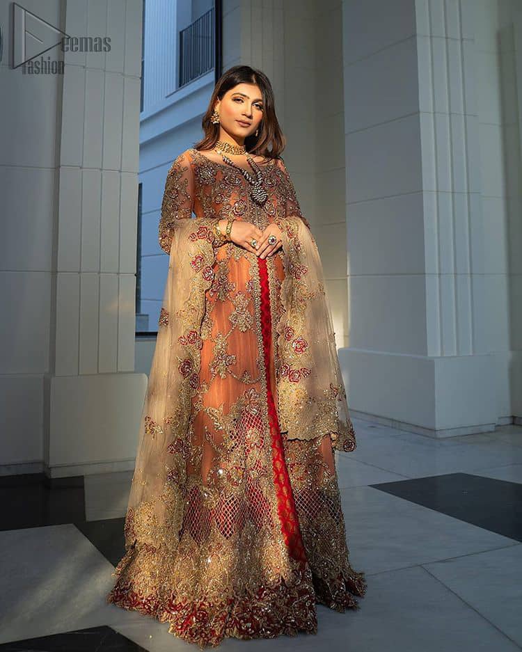 Details make perfection and perfection is not a detail”-DaVinci. This beautiful quote embodies what the DeemasFashion tries to achieve in its every ensemble which is customised to perfection. This beautiful play of red and orange makes for a stunning. The upper layer of maxi is beautifully crafted with multiple color zardozi work and embroidered jaal. The bottom of inner are even more enhanced with golden zardozi embellishment and finished with scallops. It comprises with churidar pajama and fawn chiffon dupatta. The embellished alluring cut work floral border gives the perfect ending to veil or dupatta.