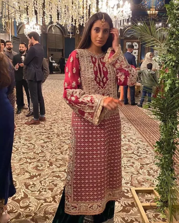 The new season is all about making a statement. An sensational affair so timeless and magnificent, beautifully crafted in hues of golden. Embellishd bodice with zardozi work and bell sleeves adorned with tassels finishing make the outfit more beautiful. Balance the look with bottle green palazzo pants highlighted with embroidered borders at the bottom and red organza dupatta with sequins spray all over. Craftmanship and skills you've never witnessed before.