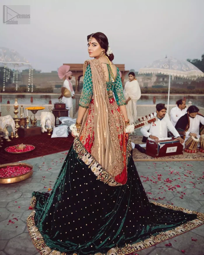 Classic, timeless and truly beautiful, our bridal dress is perfect for your unforgettable day. Excellence of craftsmanship is evident with intricate detailing that features the use of zardozi work. The blouse is beautifully adorned with geometric patterns and floral embroidery with golden zardozi work and finished with dangling beads. Complete the look with artfully coordinated lehenga which is ornamented with a bold and captivating design with a traditional intricate embroidery and scattered tiny floral motifs. The combination of red and orange for lehenga is also captivating. Elegance is personified when it gets paired up with golden dupatta having four sided embroidered border.