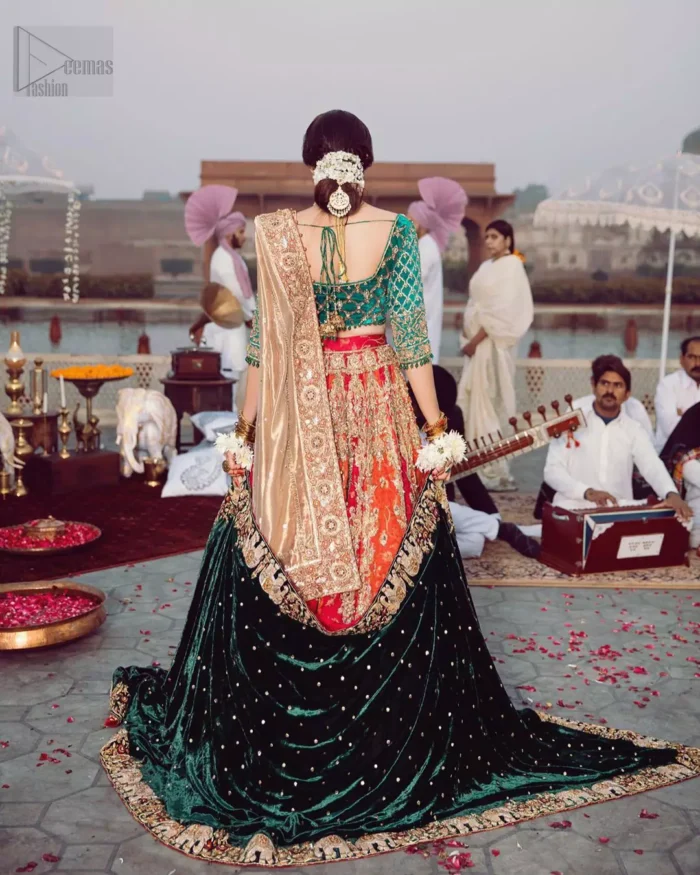Classic, timeless and truly beautiful, our bridal dress is perfect for your unforgettable day. Excellence of craftsmanship is evident with intricate detailing that features the use of zardozi work. The blouse is beautifully adorned with geometric patterns and floral embroidery with golden zardozi work and finished with dangling beads. Complete the look with artfully coordinated lehenga which is ornamented with a bold and captivating design with a traditional intricate embroidery and scattered tiny floral motifs. The combination of red and orange for lehenga is also captivating. Elegance is personified when it gets paired up with golden dupatta having four sided embroidered border.