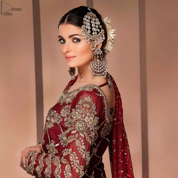 This style-savvy bride totally pulled off our classic bridal wear with an unmatchable grace and giving major bridal goals. The lehenga colour is the perfect feminine and delicate shade with its meticulously crafted fabrication with geometrically embellished border filled with gorgeous tiny floral motifs in it. The shirt is beautifully ornamented with geometrically arranged motifs and intricate details at the bottom. The zardozi embroidery is done in the shade of tan. Pair it up with maroon organza dupatta adorned with sterling sequences and four-sided embellished borders to give it a regal look.