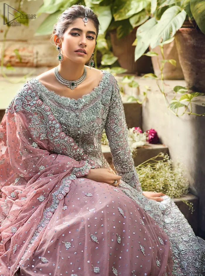Intricate details, flamboyant silhouettes and mastery of colour are what makes this dress stand out from the rest. This is one of the elegant pieces that are sure to stay in your heart. Unique craftsmanship and detailed embellishments bring heavenly hued gossamer fabrics to life. The gown is beautifully sculptured with floral embroidery, adorned with intricately embellished borders with silver kora, Dabka, pearl and sequins work all over. Pair it up with a pink inner maxi and ruffled sharara gives the perfect ending to the outfit. The dupatta incorporates beautifully designed borders on all four sides, focusing on the heavily embellished pallu borders to give it a perfect maharani look.