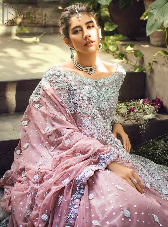 Intricate details, flamboyant silhouettes and mastery of colour are what makes this dress stand out from the rest. This is one of the elegant pieces that are sure to stay in your heart. Unique craftsmanship and detailed embellishments bring heavenly hued gossamer fabrics to life. The gown is beautifully sculptured with floral embroidery, adorned with intricately embellished borders with silver kora, Dabka, pearl and sequins work all over. Pair it up with a pink inner maxi and ruffled sharara gives the perfect ending to the outfit. The dupatta incorporates beautifully designed borders on all four sides, focusing on the heavily embellished pallu borders to give it a perfect maharani look.