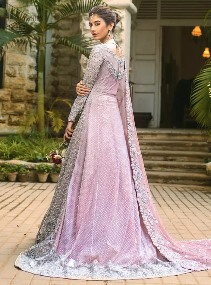 Intricate details, flamboyant silhouettes and mastery of colour are what makes this dress stand out from the rest. This is one of the elegant pieces that are sure to stay in your heart. Unique craftsmanship and detailed embellishments bring heavenly hued gossamer fabrics to life. The gown is beautifully sculptured with floral embroidery, adorned with intricately embellished borders with silver kora, Dabka, pearl and sequins work all over. Pair it up with a pink inner maxi and ruffled sharara gives the perfect ending to the outfit. The dupatta incorporates beautifully designed borders on all four sides, focusing on the heavily embellished pallu borders to give it a perfect maharani look.