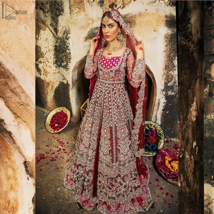 Complete your big day with the perfect dress in our selection of stunning wedding dresses. This artisanal piece is rendered in grace and timelessness. The bodice with a sweetheart neckline is adorned in richly zardozi work with fabulous sparkle. The rest of the dress is beautifully crafted with floral motifs, geometric patterns and embroidered lines along the length. Pair it up with a red lehenga emphasized with multiple colour kora, dabka, tilla and sequins work. Furthermore, the outfit is also adorned with sequins spray all over the ground. Complete the look with an artfully coordinated dupatta having embellished scalloped borders and scattered tiny floral motifs.